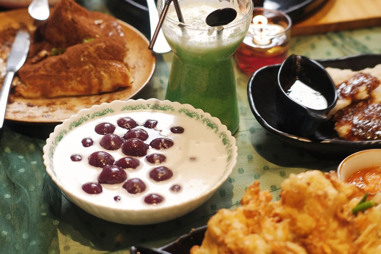 Assorted fried Ramadan festive foods next to fresh fruit, illustrating balanced Iftar plate choices
