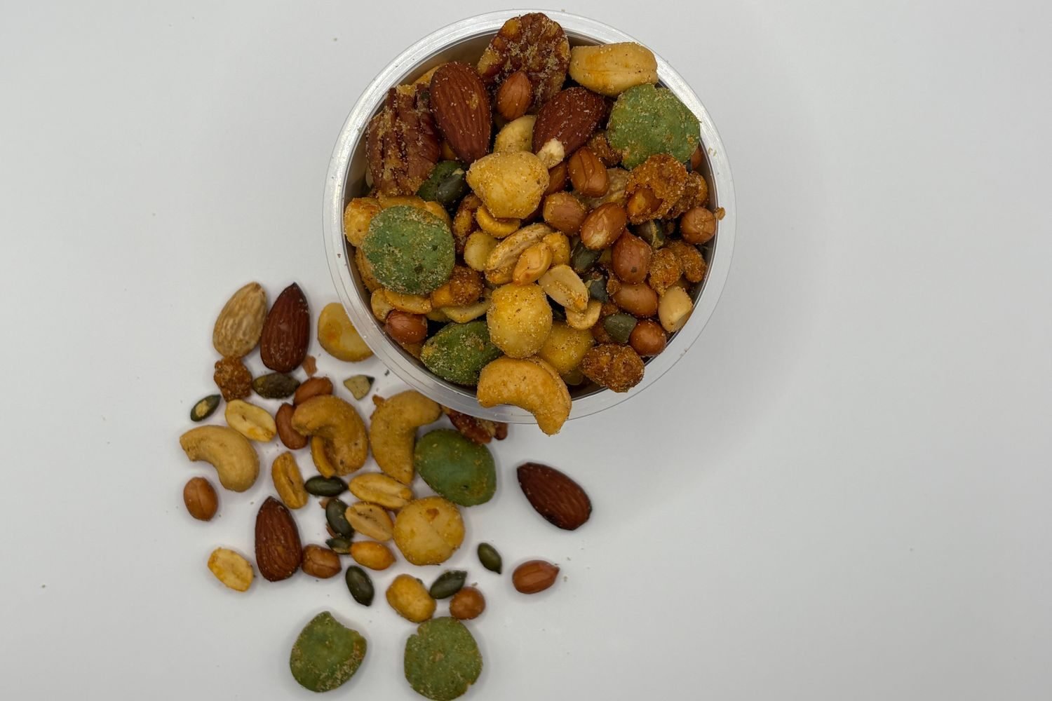 Portable healthy snacks including roasted makhana, roasted chana, and trail mix packed in small reusable containers for travel