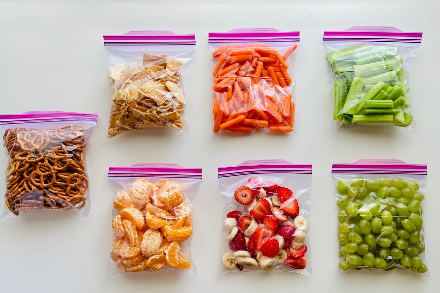 Person grabbing a pre-portioned snack pouch from a travel bag at an airport gate