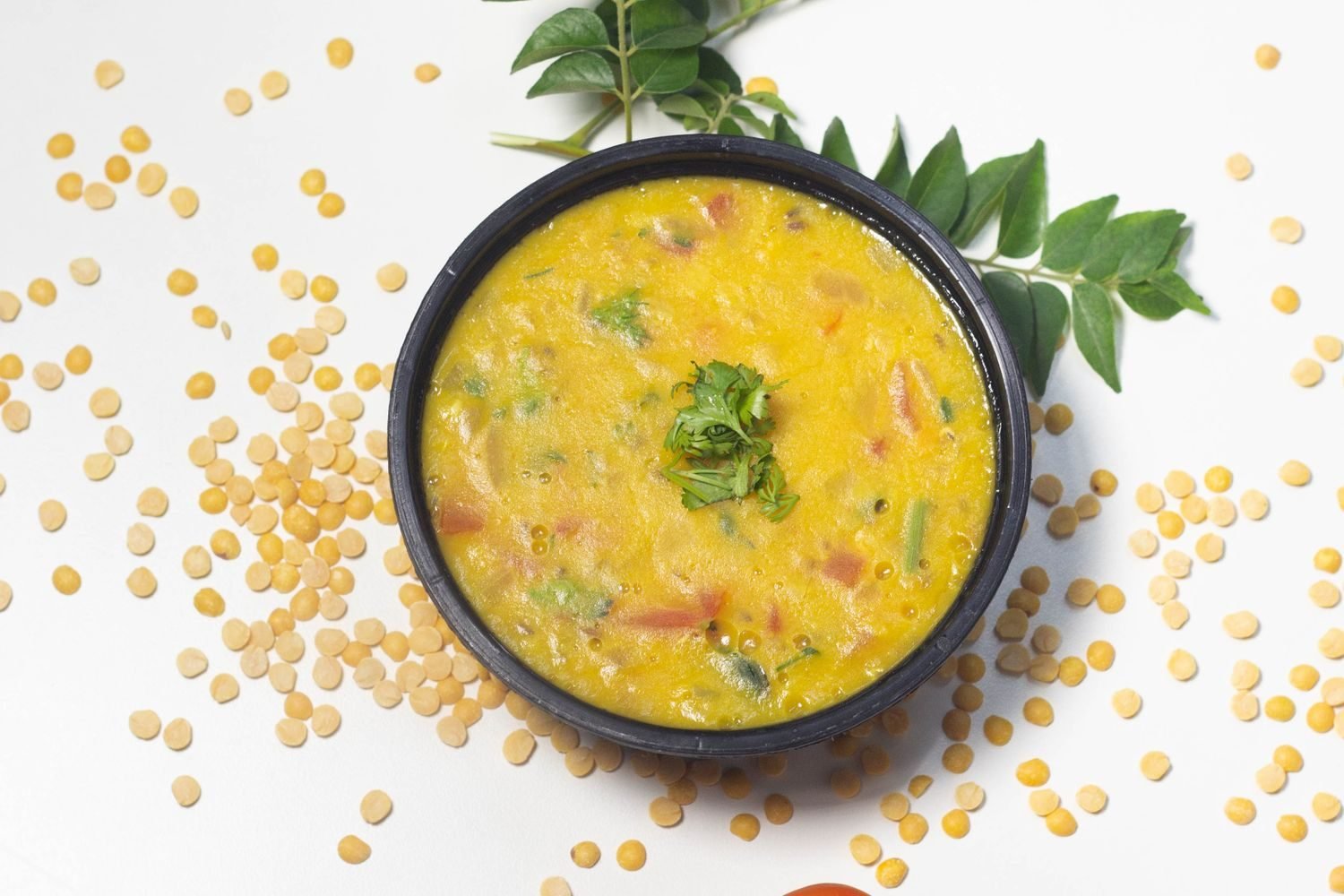 Besan chilla and moong dal chilla served on a plate with curd for a high protein Indian breakfast