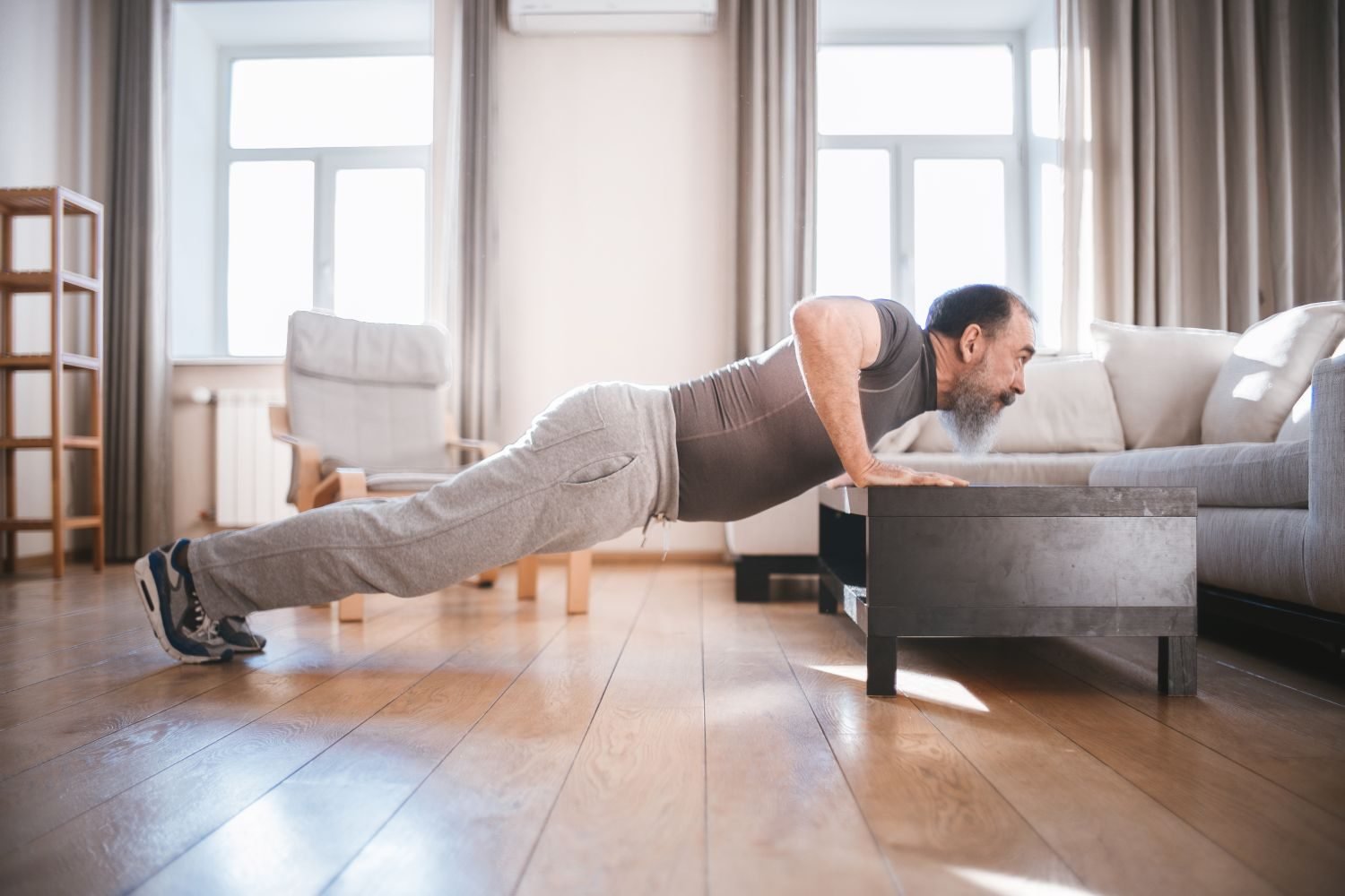 Man doing an elevated push-up on a coffee table at home
