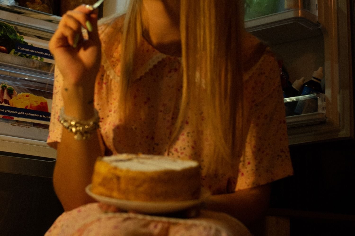 Person checking blood glucose or insulin sensitivity data next to a sleep tracker on a nightstand
