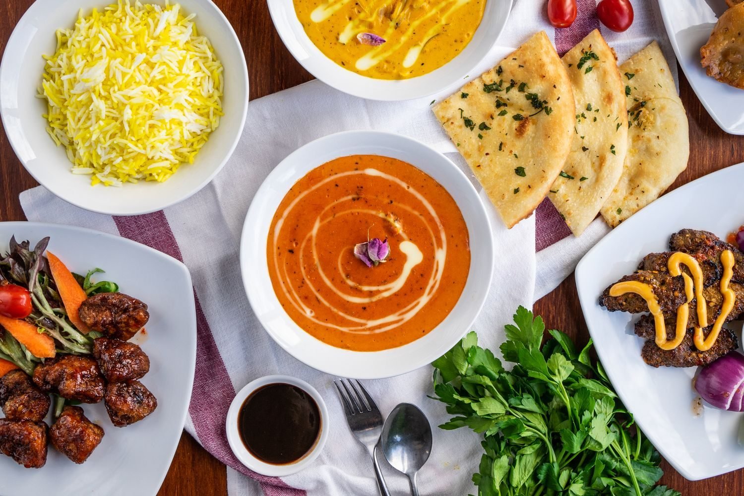 Indian restaurant thali with tandoori chicken, dal, sabzi, and roti