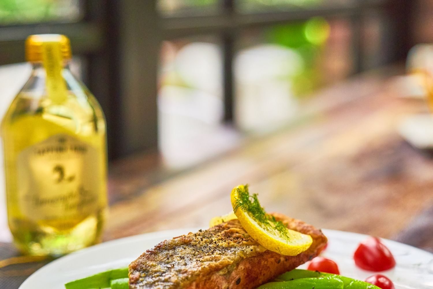 Grilled salmon with steamed vegetables plated as a heart-healthy portion for someone managing heart disease