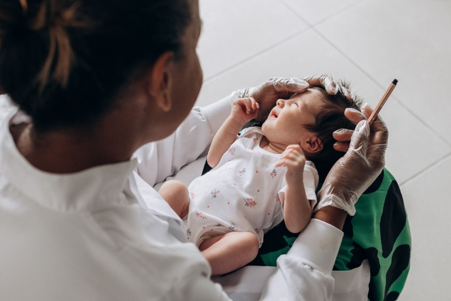 Parent checking infant vitamin D and iron supplement dosage against pediatrician guidance
