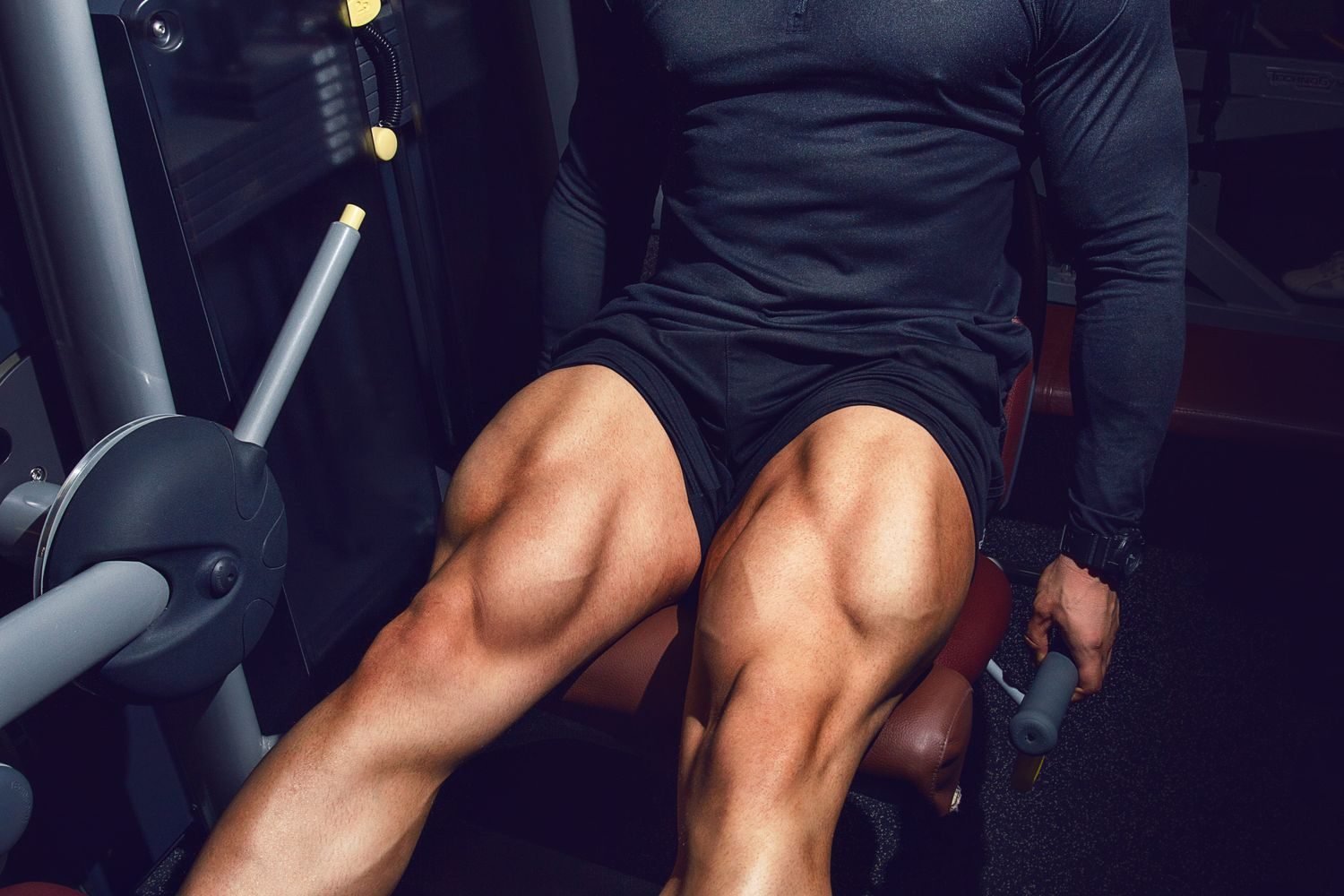 Man using a leg extension machine at the gym