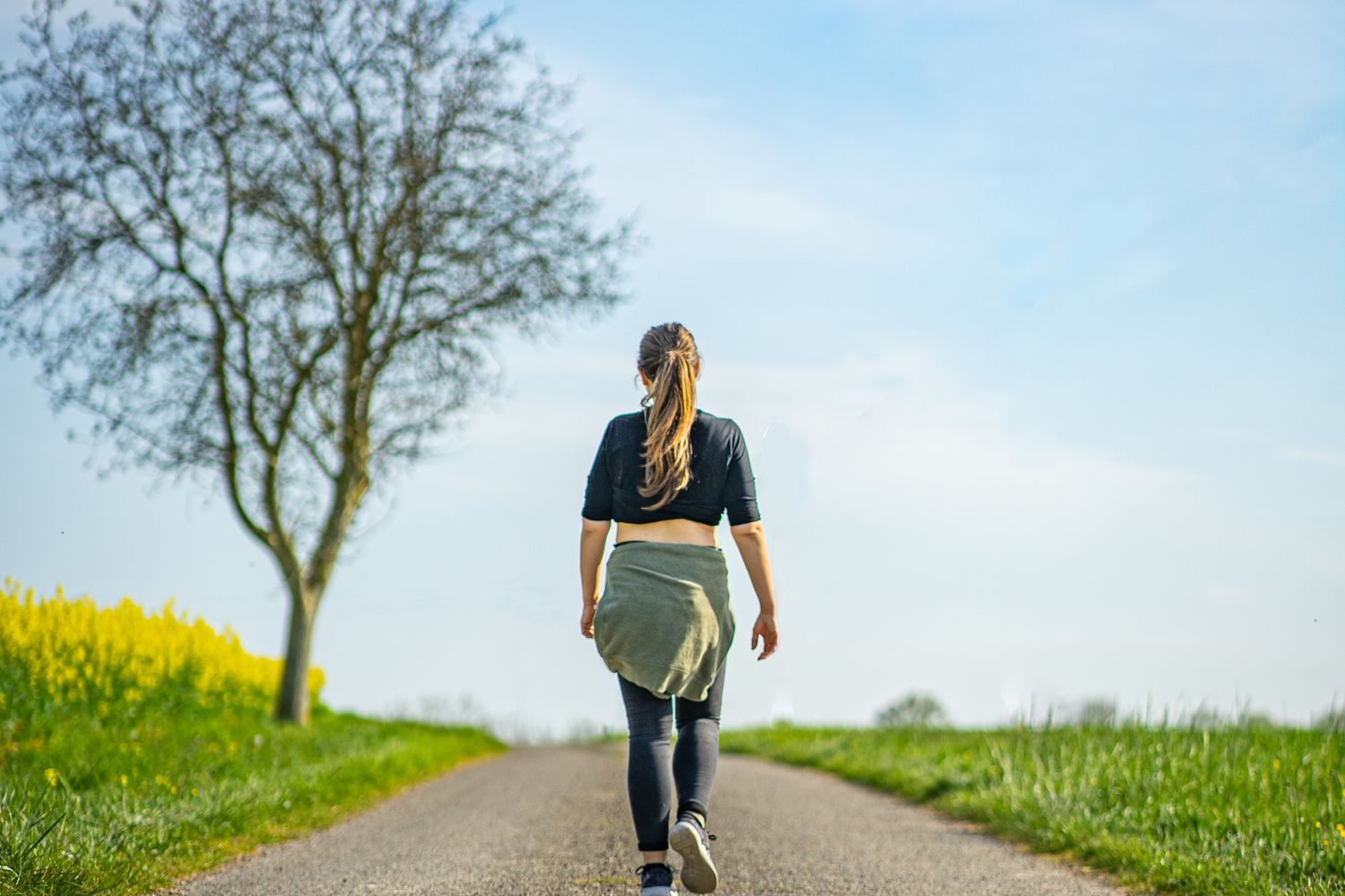 Person walking outdoors with a visual illustration of reduced pressure on the knee joint from weight management