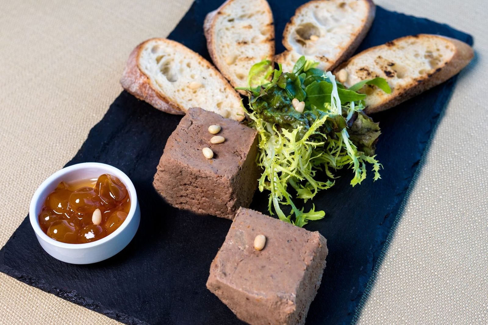 Small serving of liver pate on toast with nutrition label details in background