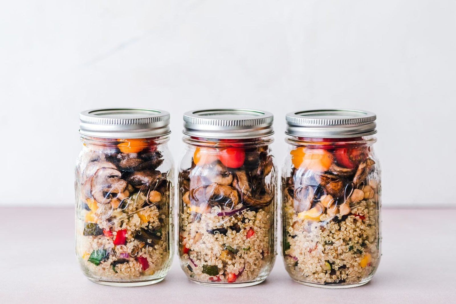 Person meal prepping vegetables, whole grains, and lean protein for a liver-friendly diet