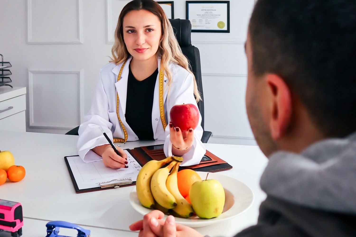 Doctor discussing low sodium diet plan with patient reviewing kidney and heart health