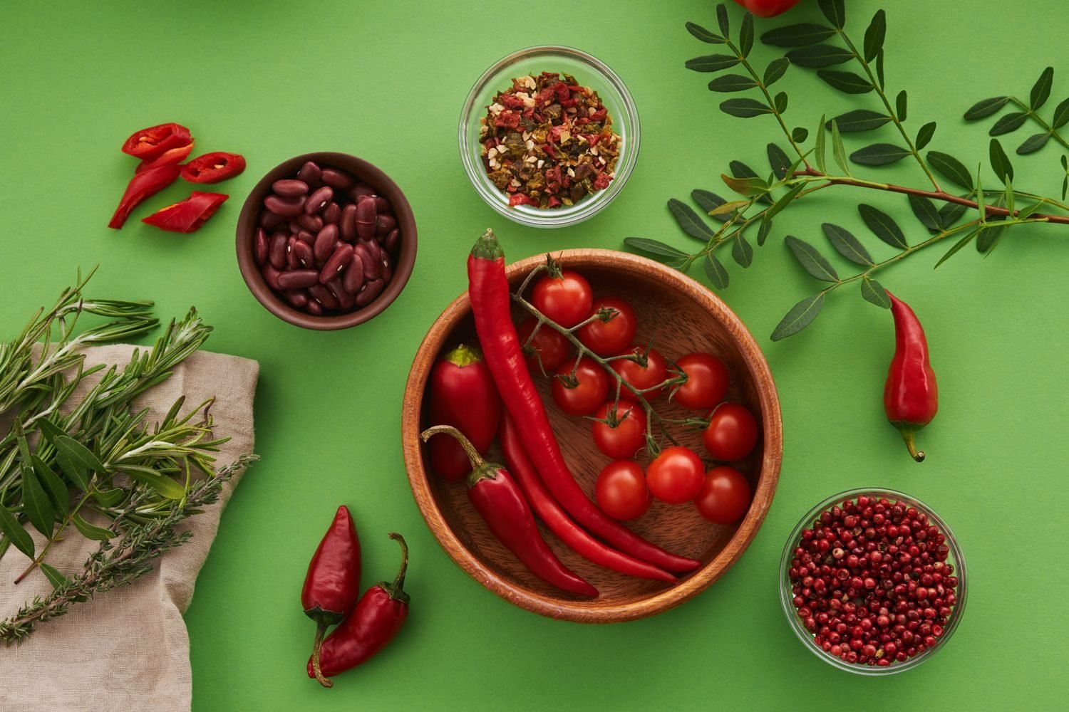Assortment of foods marketed as metabolism boosters including green tea, chili peppers, and coffee beans on a kitchen counter