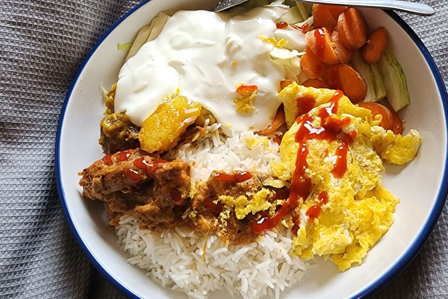 Grilled chicken breast, eggs, Greek yogurt, and other high-protein foods arranged on a plate