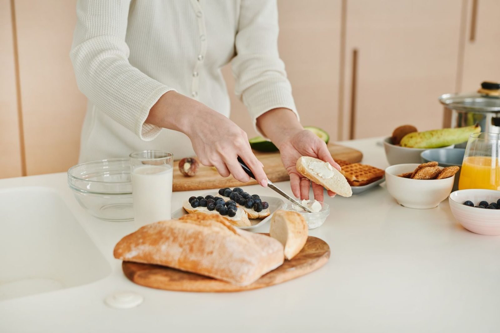 Person planning a balanced meal with fruits, vegetables, protein, and whole grains on a plate