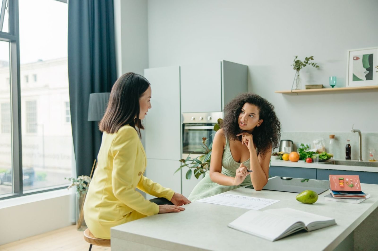 Nutrition consultant reviewing a client's food diary and health history during a consultation