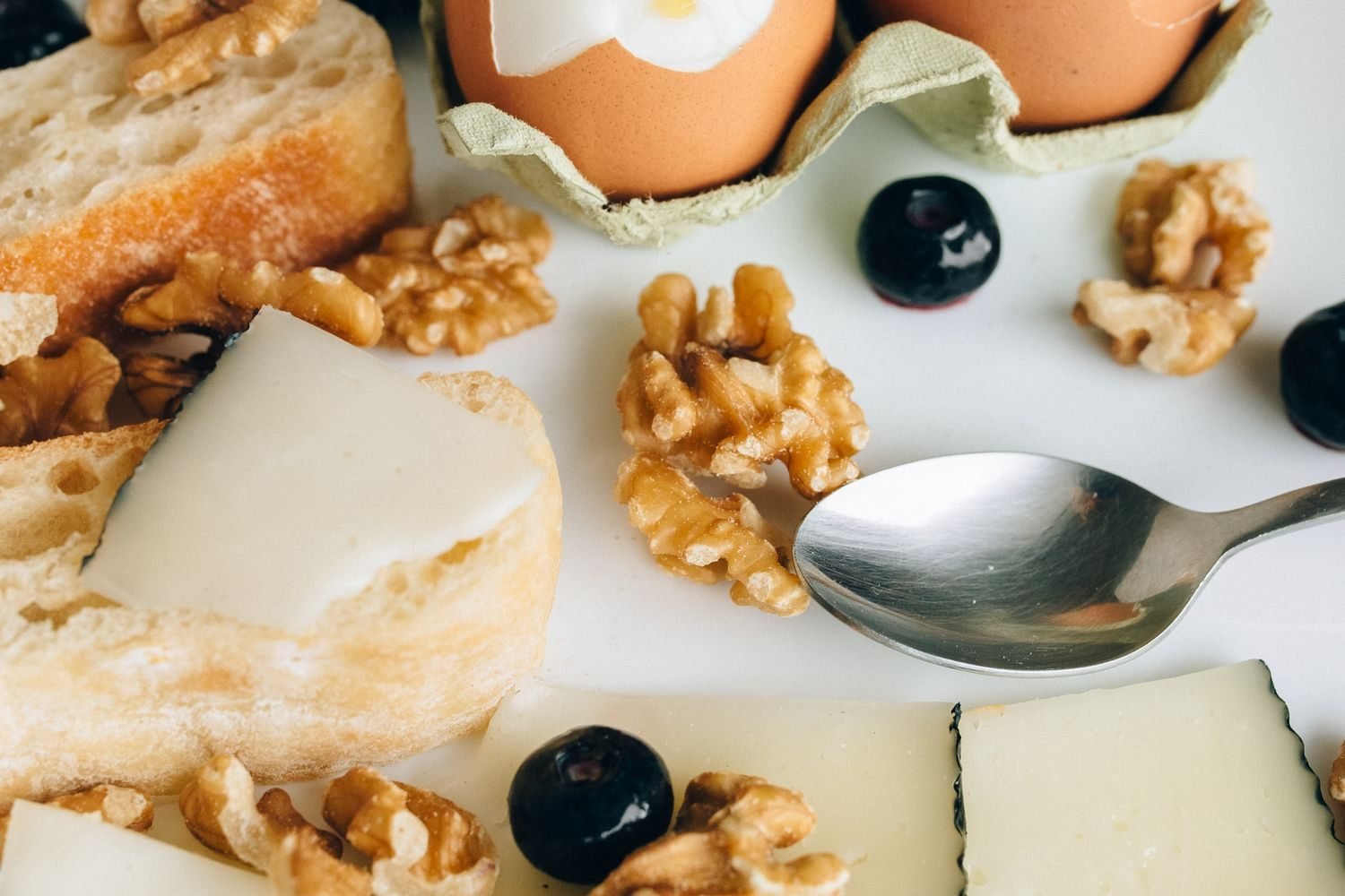 Calorie dense whole foods for weight gain including nuts milk paneer eggs and whole grains arranged on a table