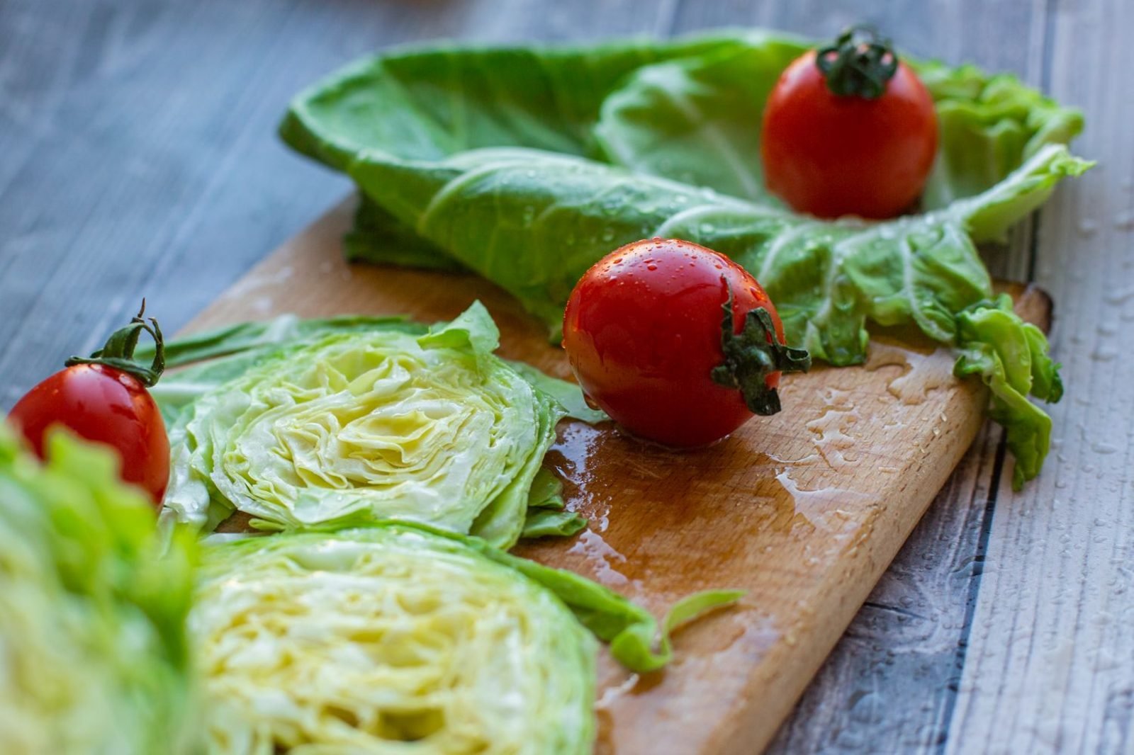 Colorful high-water-content vegetables like cucumber, tomato, and leafy greens used in volumetrics eating