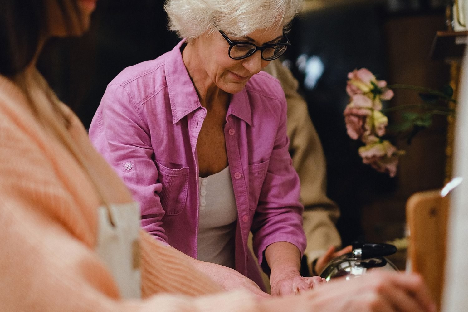 Caregiver preparing a soft, fork-tender meal for an elderly parent with chewing difficulty