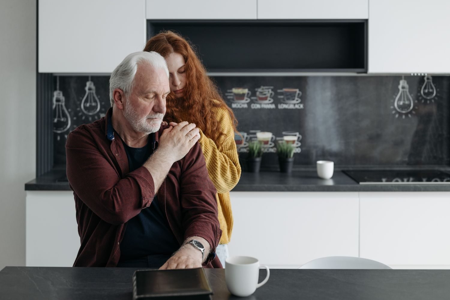 Adult daughter reviewing a hydration and meal schedule with her elderly father