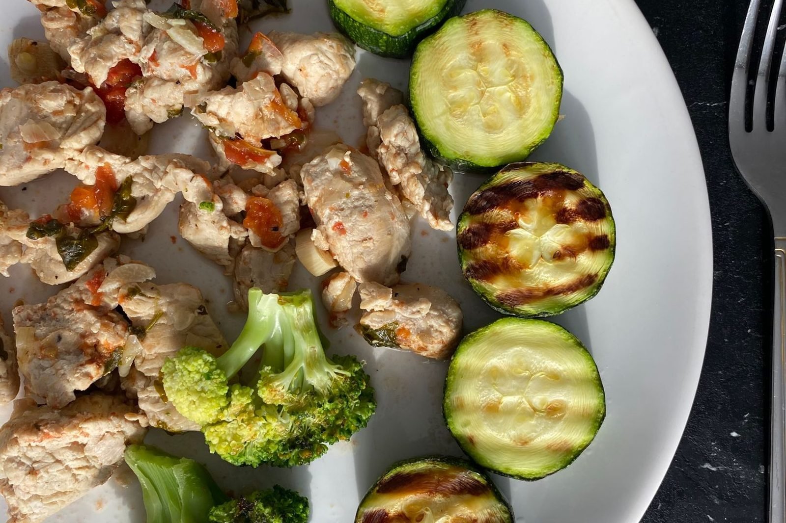 Plate of grilled chicken, vegetables, and whole grains representing a balanced nutrition plan for weight loss