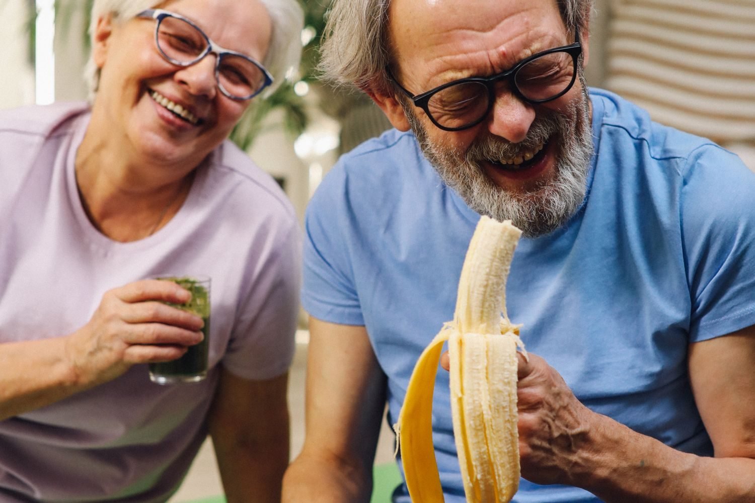A senior couple sharing a healthy, protein-rich lunch together at home, illustrating a structured daily eating routine