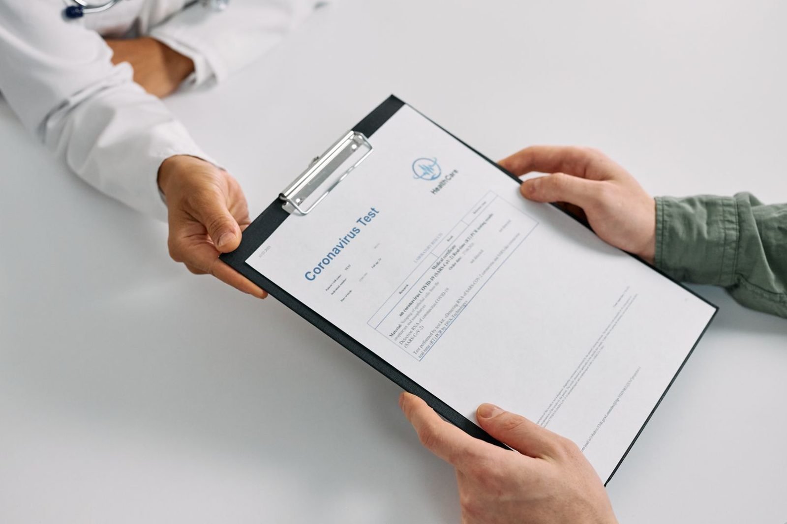 Doctor reviewing a blood test report with a patient in a clinic