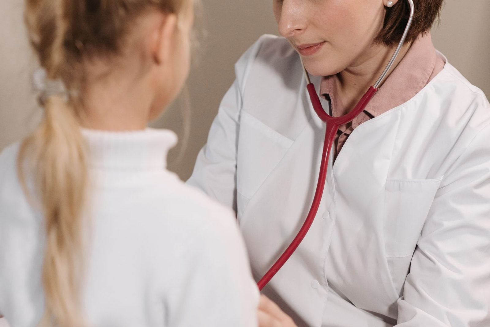 Doctor checking a child's growth and nutrition status to screen for protein-energy malnutrition