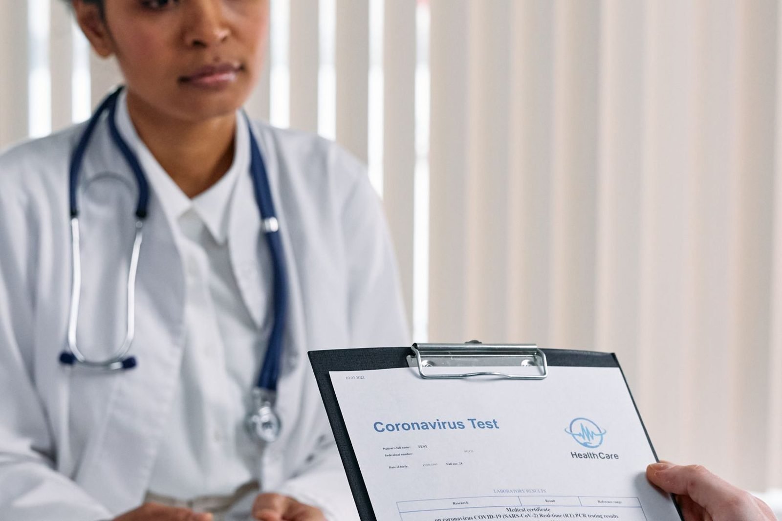 Doctor reviewing blood test results with a patient to check for nutrient deficiency markers