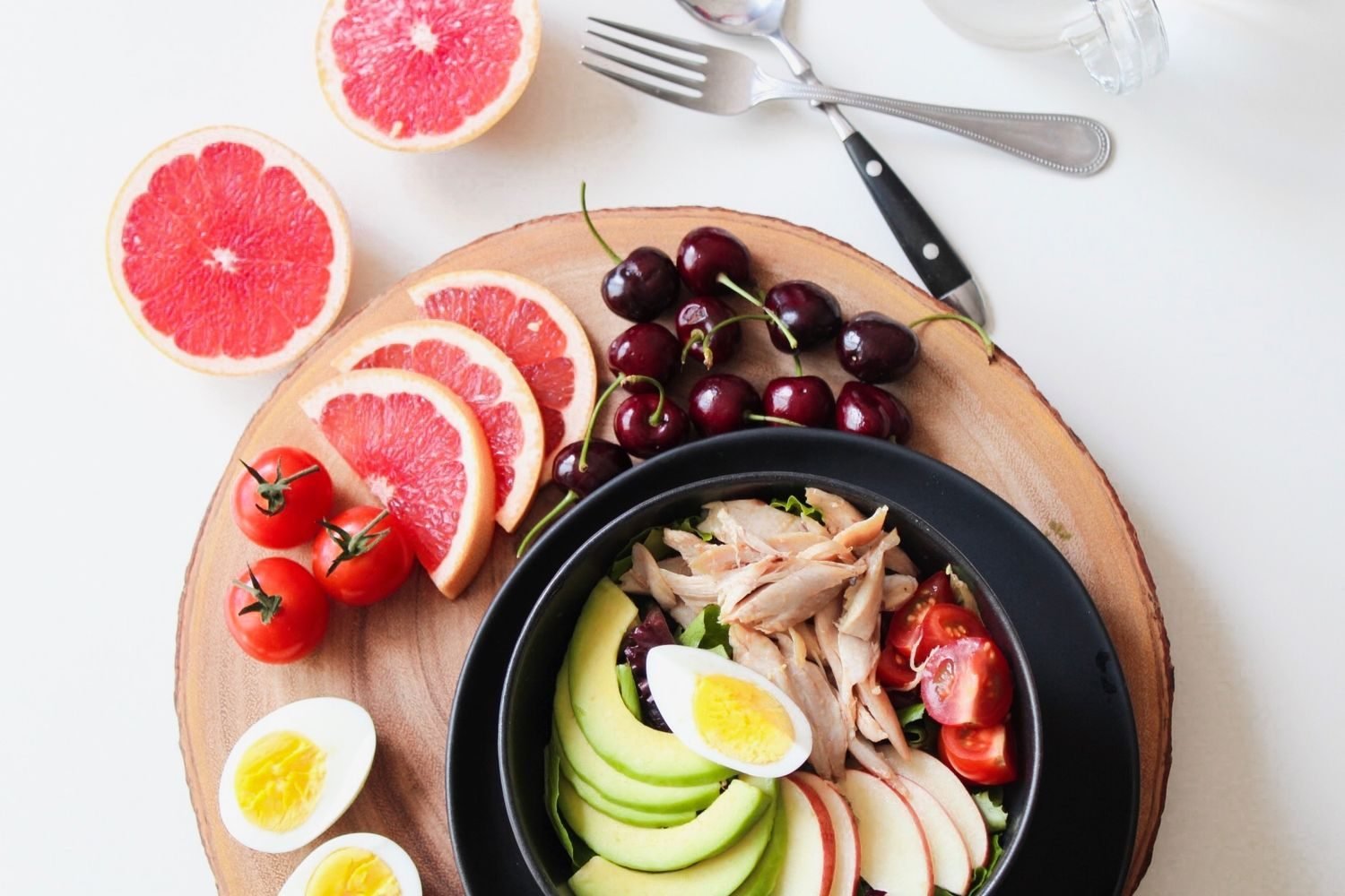 Flat lay of whole foods rich in immune-supporting nutrients including citrus, lean protein, nuts, and leafy greens
