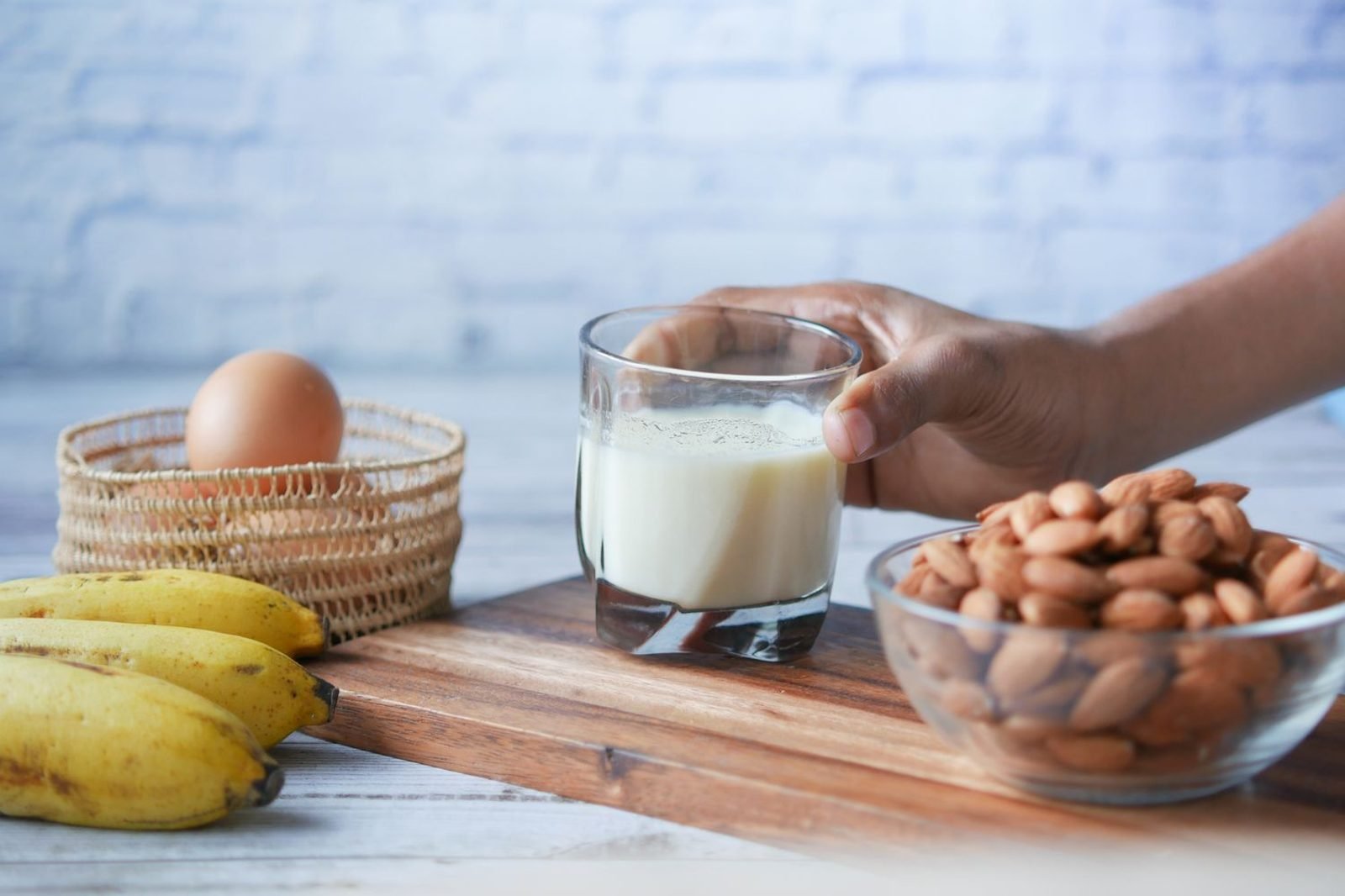 Pregnant woman preparing a protein and calcium rich meal with eggs, dairy, and leafy greens