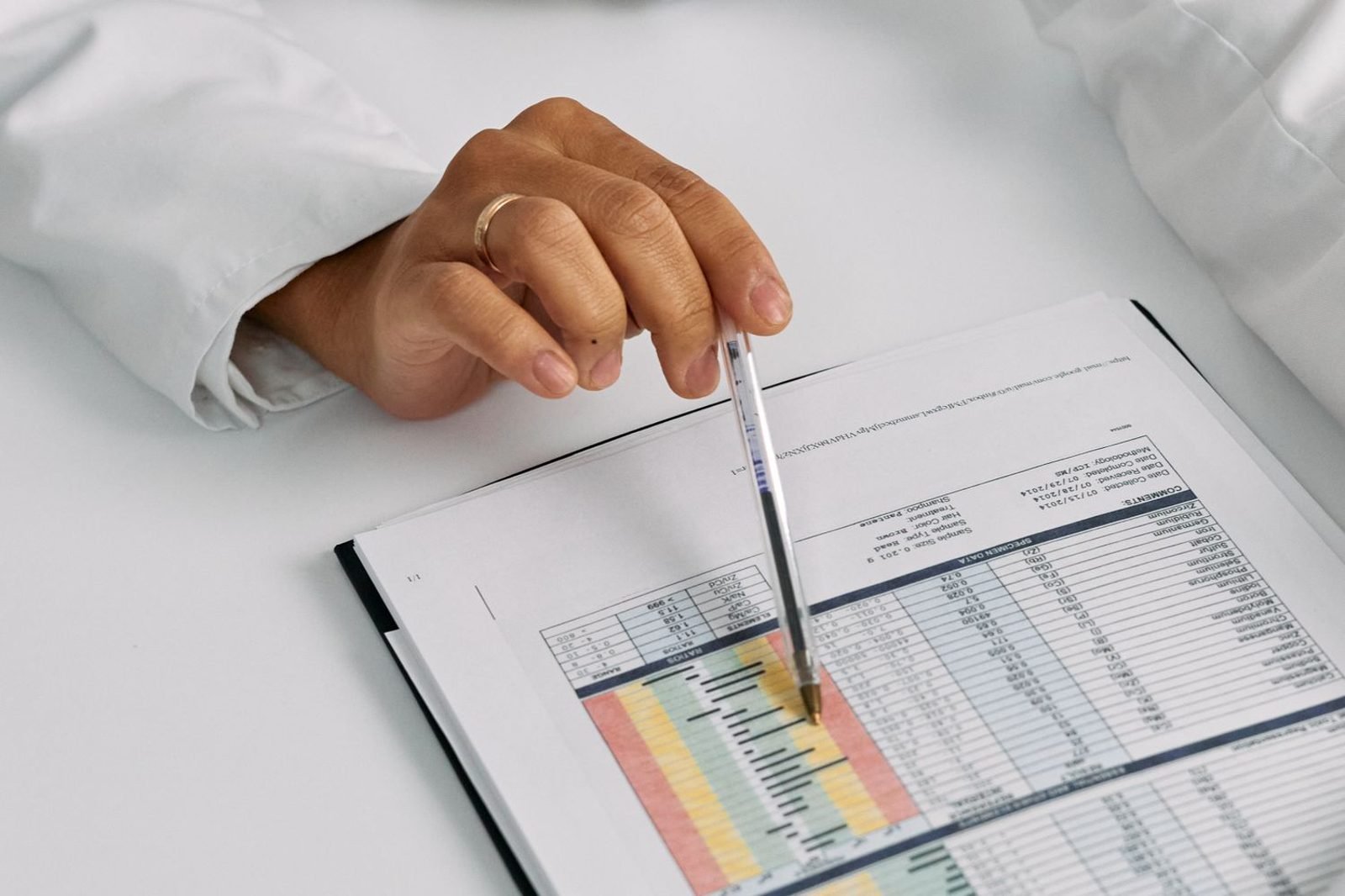 Doctor reviewing prenatal vitamin and nutrient intake chart with a pregnant patient