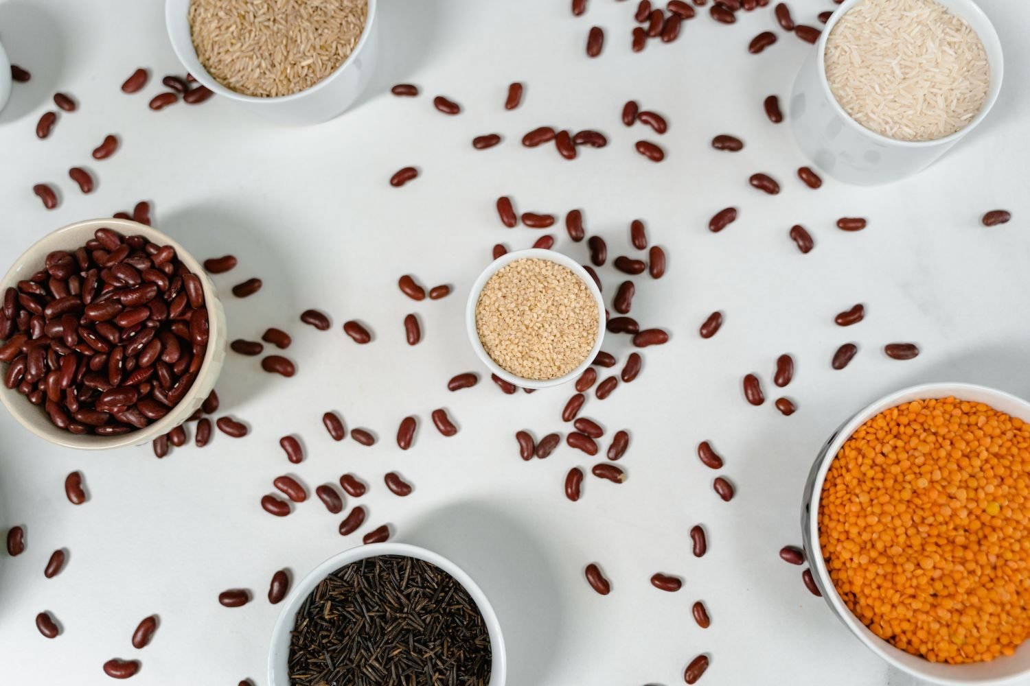 Comparison of protein-rich foods including eggs, salmon, lentils, and quinoa arranged on a table