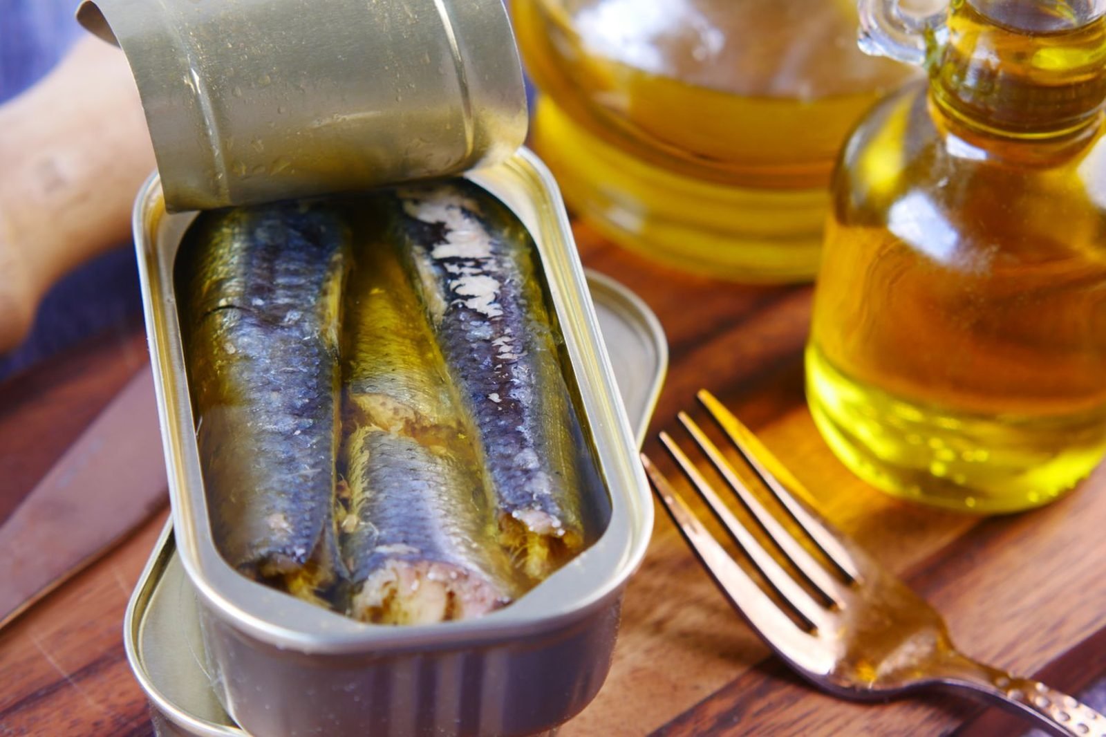 Kitchen table with cooking oils, fish, and flaxseed illustrating the omega-3 to omega-6 balance in everyday eating