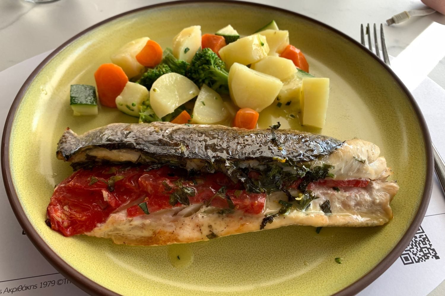 Colorful plate of vegetables, whole grains, legumes, and a small portion of fish representing a flexible plant-forward meal