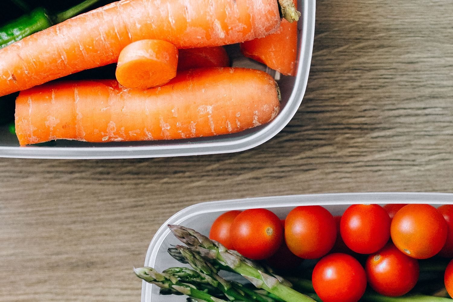 Batch-cooked freezer meal containers with dal, vegetables, and grains for postpartum meal prep