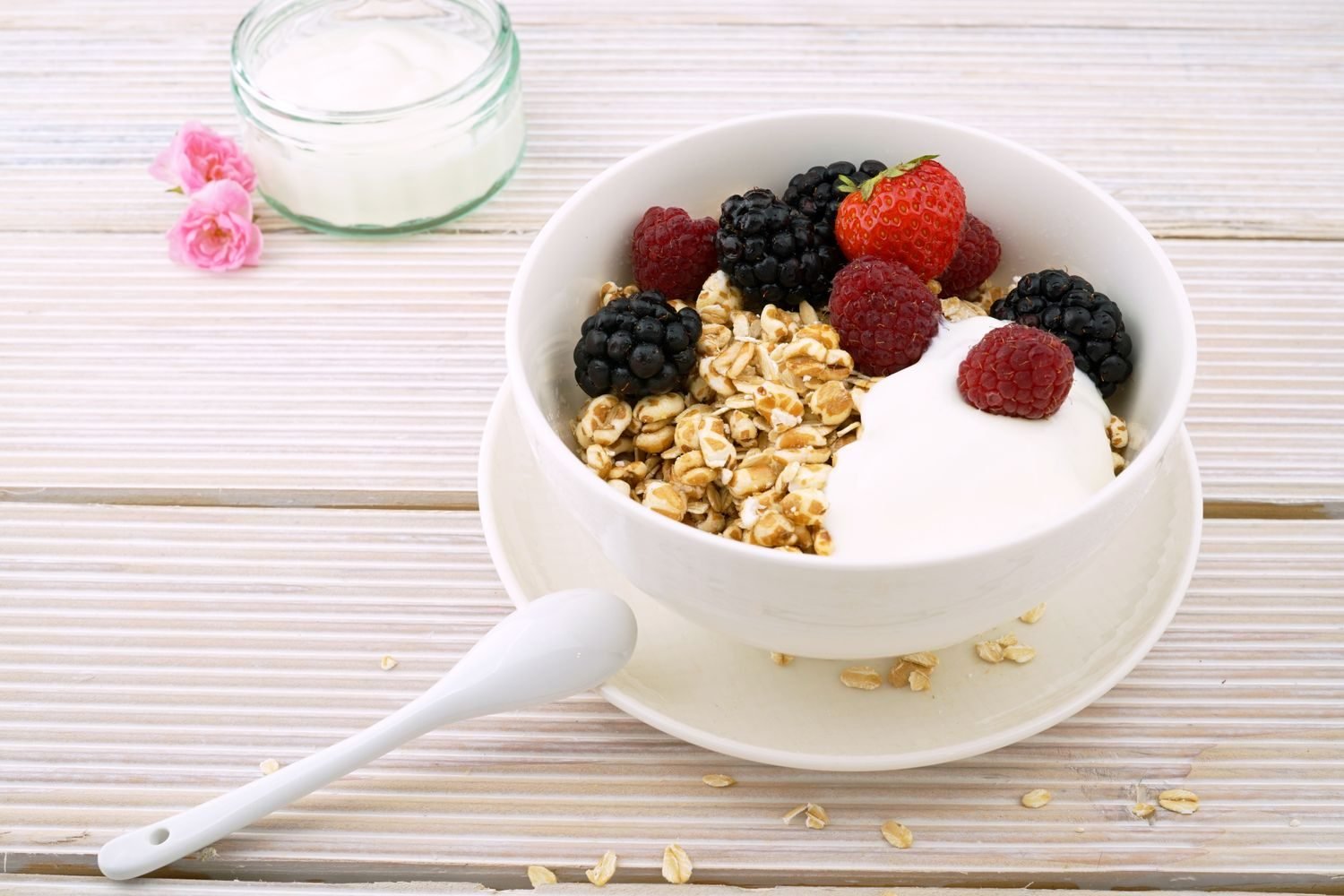 Bowl of oats topped with yogurt and mixed berries