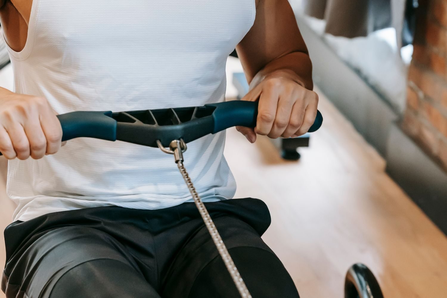 Person performing a seated cable row on a low pulley cable machine