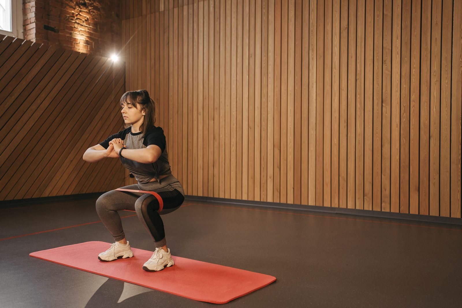 Woman performing a banded squat that targets the inner thigh adductor muscles