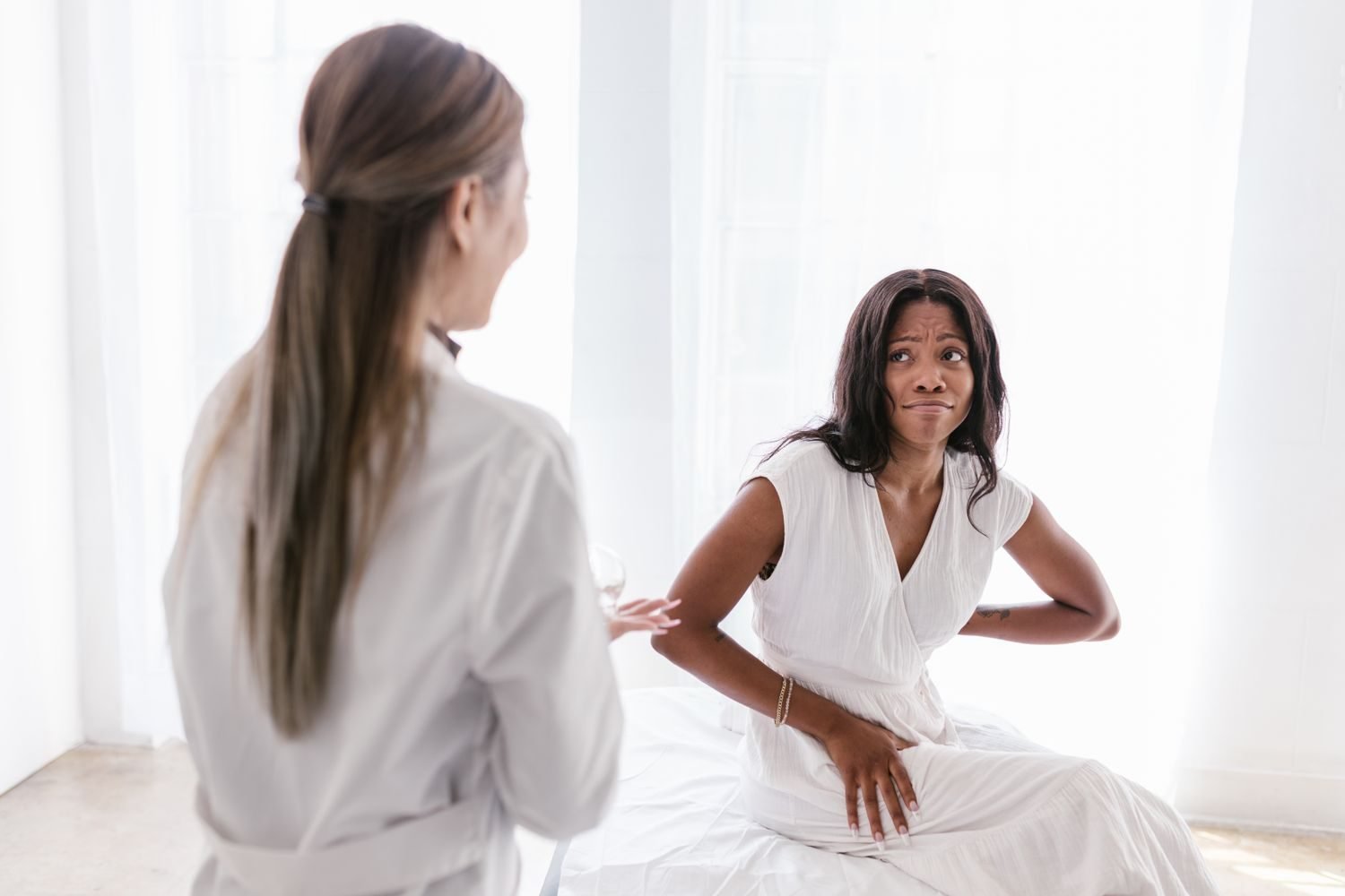 Woman reviewing a symptom checklist with a doctor during a medical consultation