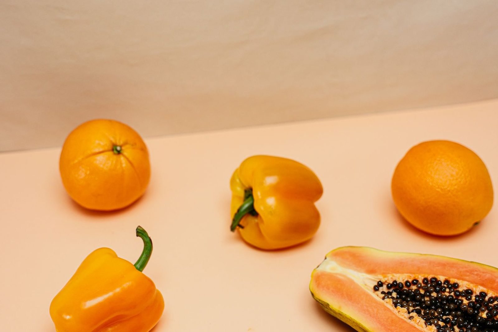 Colorful arrangement of vitamin C and antioxidant-rich foods including citrus fruits, bell peppers, and berries on a wooden table