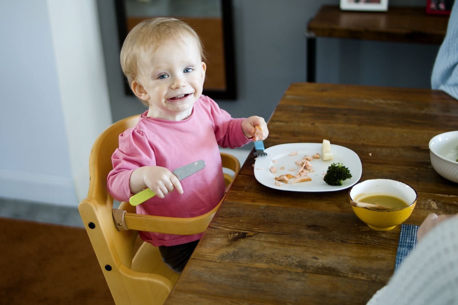 Toddler-sized portions of rice, chicken, and vegetables on a small plate, showing appropriately small serving sizes for a 1-3 year old