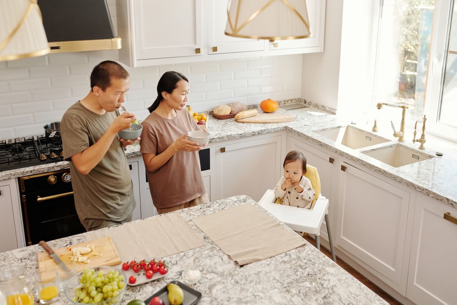 Parent and toddler eating a family meal together at the table, showing calm, pressure-free mealtime routine
