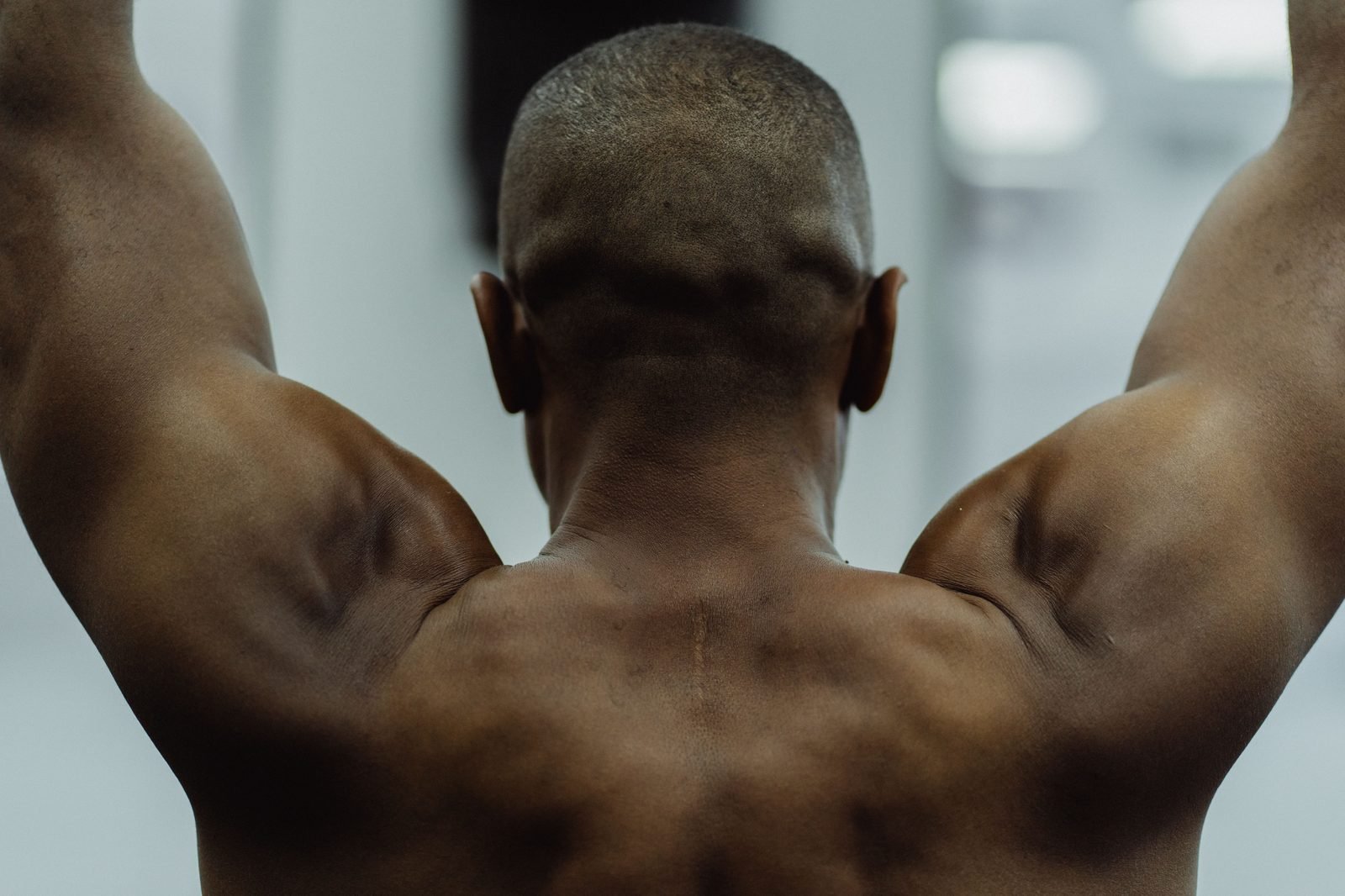 Back view of a lifter's shoulders and trapezius muscles in the gym
