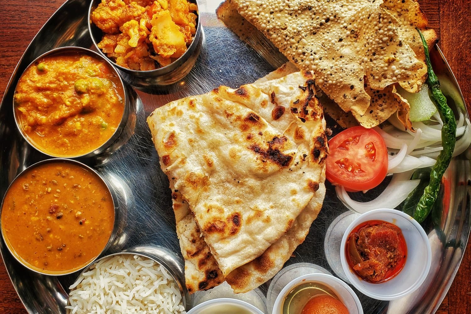 Indian vegan thali with dal, tofu sabzi, leafy greens, and fortified plant milk representing key vegan nutrients