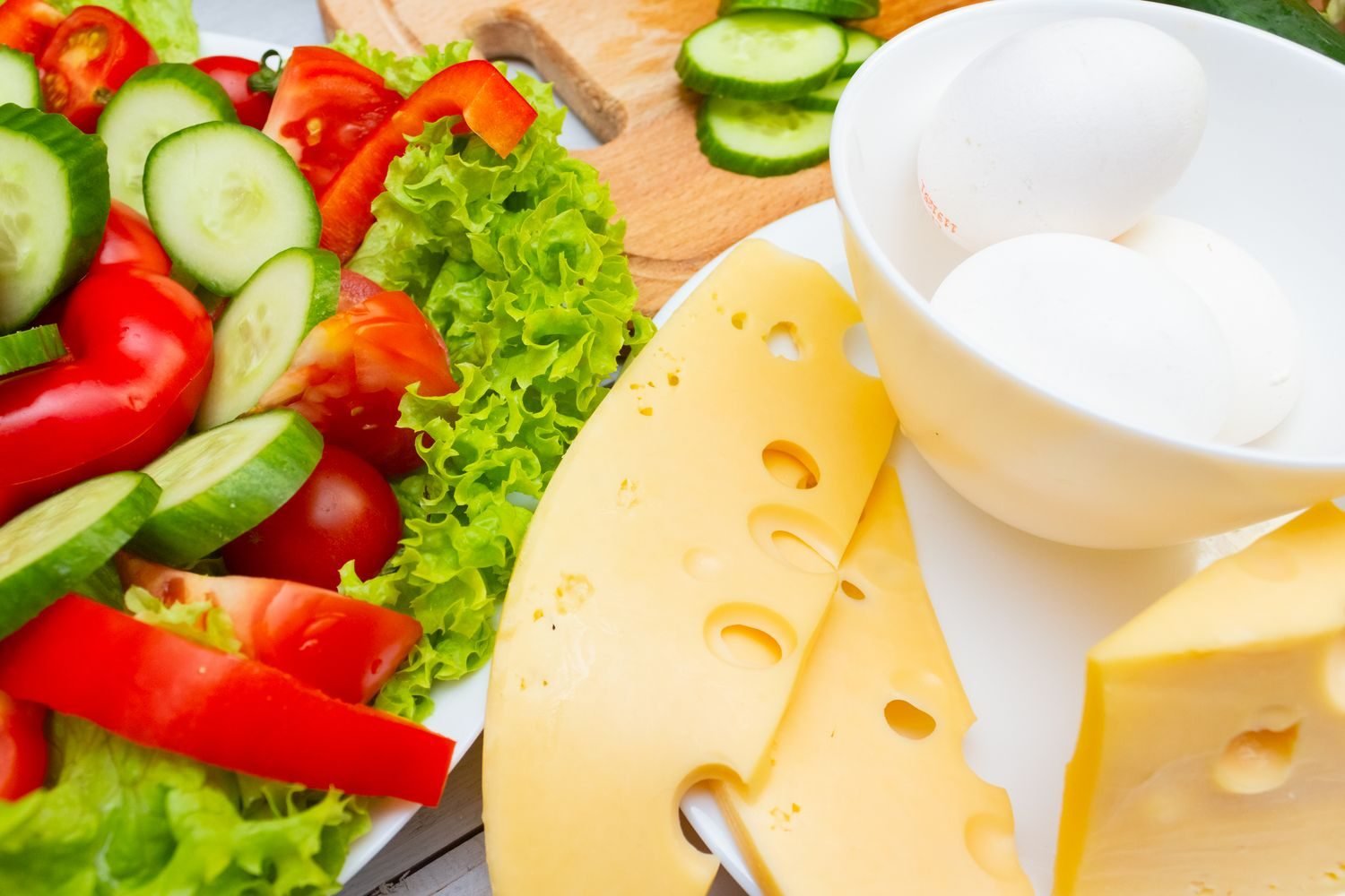 Plant-based and fortified vitamin B12 food sources including fortified cereal, dairy, eggs, and nutritional yeast on a table