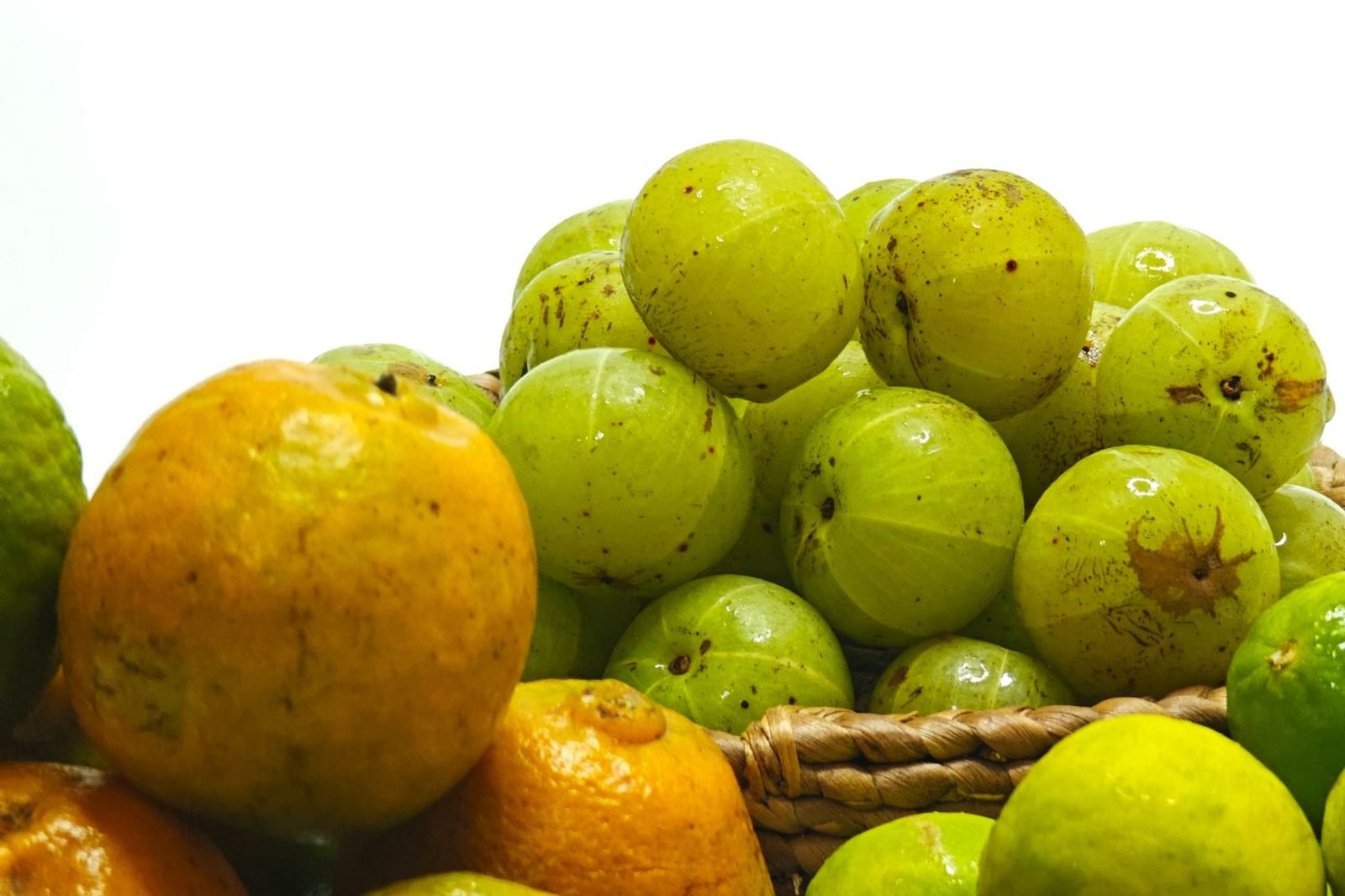 Fresh amla guava capsicum and citrus fruits arranged as natural vitamin C food sources