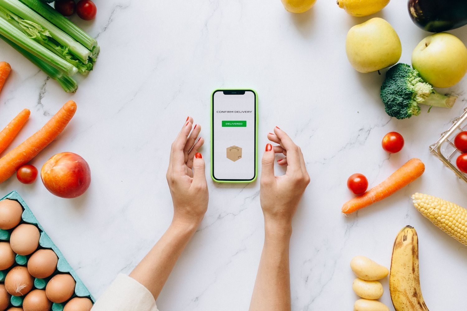 Nutrition tracking app on a smartphone showing food log and progress charts used in remote coaching