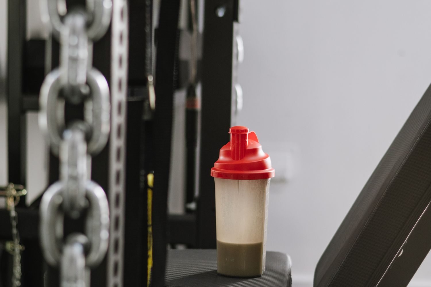 Protein shake bottle resting on gym equipment