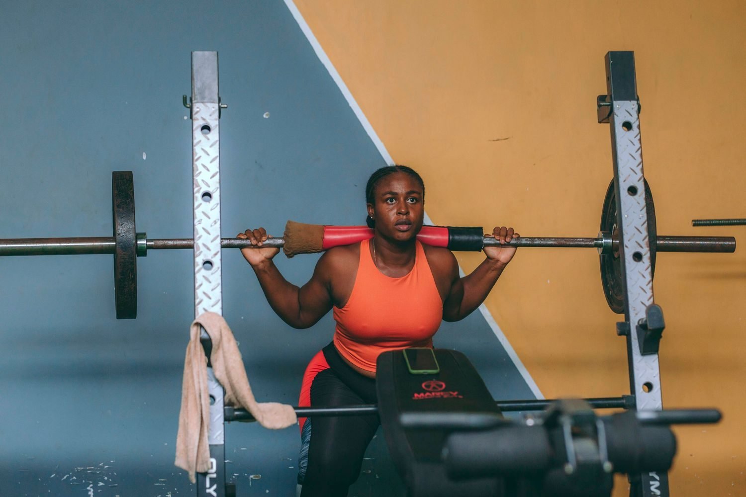 Woman performing a squat with dumbbells during a personal training session