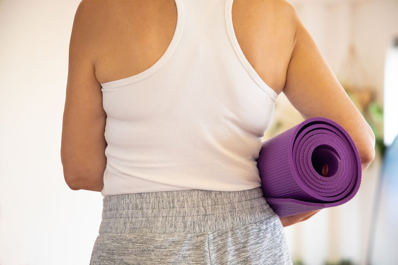 Woman performing yoga exercises as part of a weight loss routine